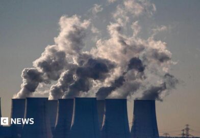Cooling towers release water vapor at the Jaenschwalde lignite-fired power station in Jaenschwalde, Germany