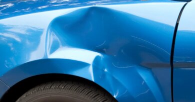 Auto accident leaving a huge dent in the left front quarter panel.