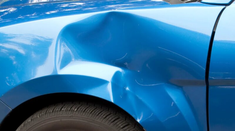 Auto accident leaving a huge dent in the left front quarter panel.