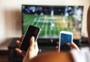 Friends using mobile phone during a tennis match on the TV.