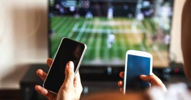 Friends using mobile phone during a tennis match on the TV.