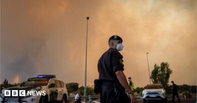 A person runs as the fire spreads in the mountains of Navaluenga, Avila, Spain