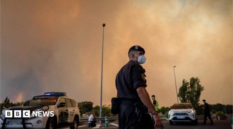A person runs as the fire spreads in the mountains of Navaluenga, Avila, Spain