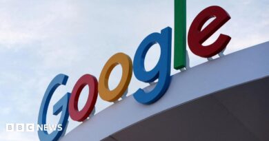 Google's primary-colored logo outside of a building.