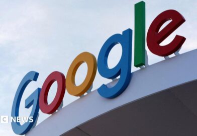 Google's primary-colored logo outside of a building.