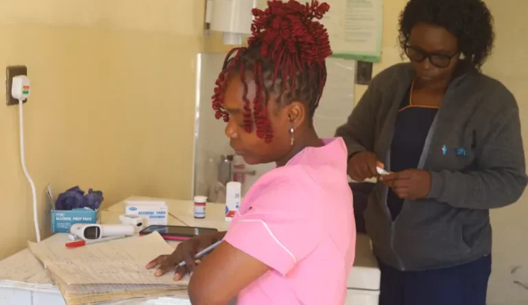 A healthworker assisting patients in a telehealth centre in Nyazura, Zimbabwe (Farai Shawn Matiashe:Al Jazeera)-1784812410