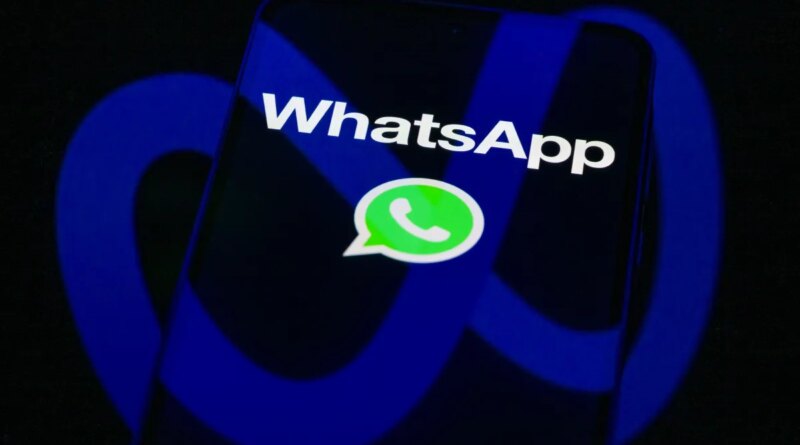 The WhatsApp logo is displayed on a mobile phone screen in this photo illustration.