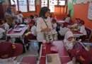 Members of school committee distribute meals to students during the kick off of President Prabowo Subianto's ambitious free meal program to feed children and pregnant women nationwide despite critics saying that its required logistics could hurt Indonesia's state finances and economy, at an elementary school in Depok, West Java, Indonesia, Monday, Jan. 6, 2025. (AP Photo/Dita Alangkara)