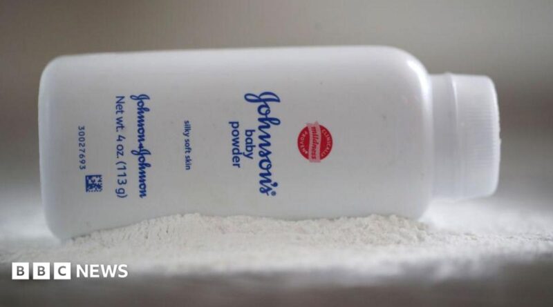 A bottle of Johnson and Johnson Baby Powder is seen in a photo illustration placed on its side on top of some white baby powder