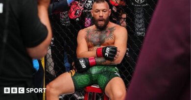 Conor McGregor sits on a stool