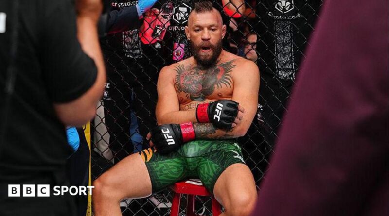 Conor McGregor sits on a stool