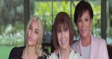 This photo shows Kim, her daughter, Mary Jo and Kris posing together smiling. They are standing by some bright pink flowers.