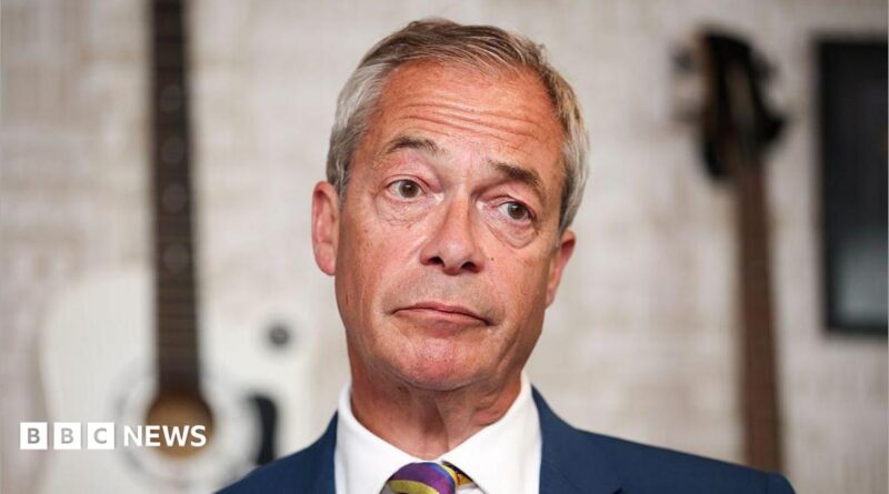 Nigel Farage in a close-up, wearing a blue suit, white shirt and stripe tie.