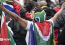 Protesters draped in South African flags in a rally against undocumented immigrants during a nationwide anti-immigration shutdown in Cape Town, South Africa, 30 June 2026.