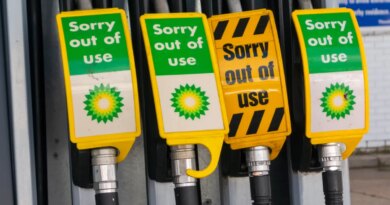 Signs warn drivers that gas pumps are out of order.