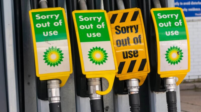 Signs warn drivers that gas pumps are out of order.
