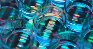 A human sample in a multi well plate ready for genetic analysis with a DNA sequence in the background