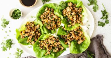 Chicken lettuce wraps on a serving platter with toppings.