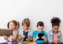 Image of four children using tablets and smartphones.