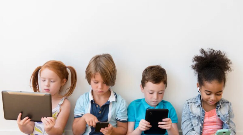 Image of four children using tablets and smartphones.