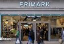 Shoppers, not in focus, walk past a Primark store in London