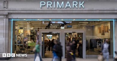 Shoppers, not in focus, walk past a Primark store in London