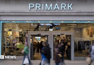 Shoppers, not in focus, walk past a Primark store in London