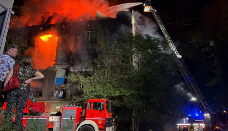 Ukrainian rescuers work to extinguish a fire at a damaged residential building following a Russian drone strike late night in Zaporizhzhia on July 12, 2026, amid the Russian invasion of Ukraine.