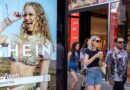 Peolep walking past a bus stop advertising for Chinese e-commerce fashion company Shein on 11 July 2026 in London.