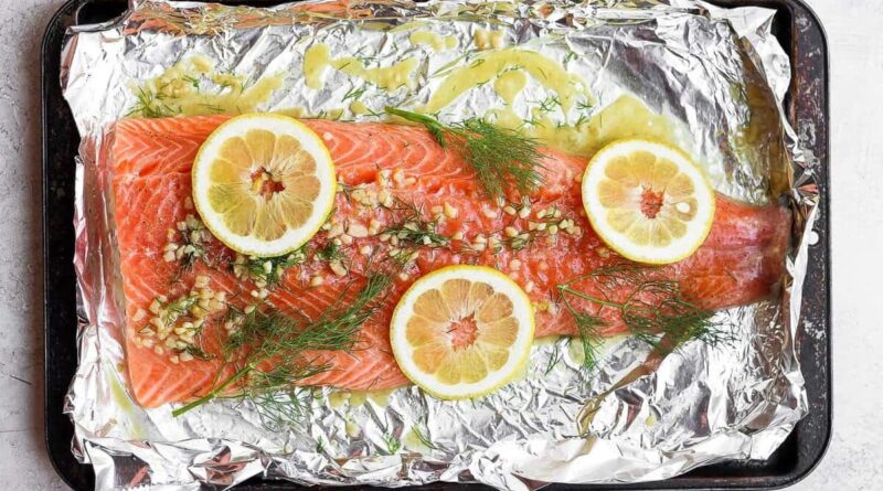 A full salmon fillet marinating in lemon dill salmon marinade