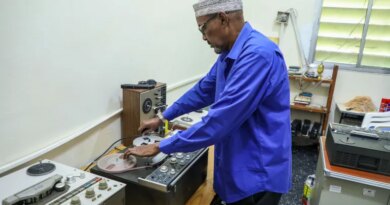 Abdiqadir Geedi Robleh cues up a tape, ready to hear a recording for the first time in years. [Abdimajid Abdillahi Farah/Al Jazeera]