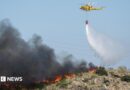 A helicopter works to extinguish flames amid deadly wildfires affecting Almeria province