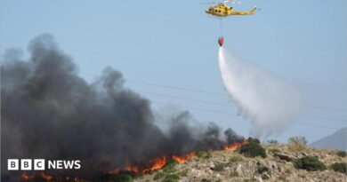 A helicopter works to extinguish flames amid deadly wildfires affecting Almeria province