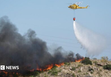 A helicopter works to extinguish flames amid deadly wildfires affecting Almeria province