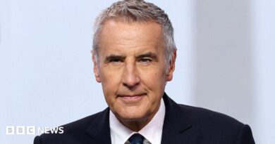Dermot Murnaghan, with short dark grey hair, in a suit looking slightly off camera 