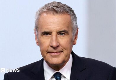 Dermot Murnaghan, with short dark grey hair, in a suit looking slightly off camera 