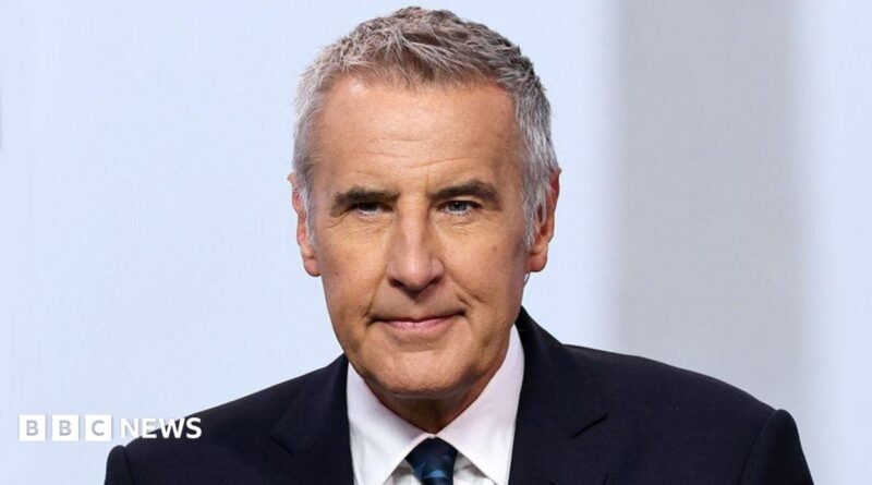Dermot Murnaghan, with short dark grey hair, in a suit looking slightly off camera