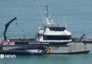 A Border Force boat with a dinghy. 