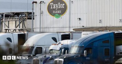 View of Taylor Farms building with trucks in front of it