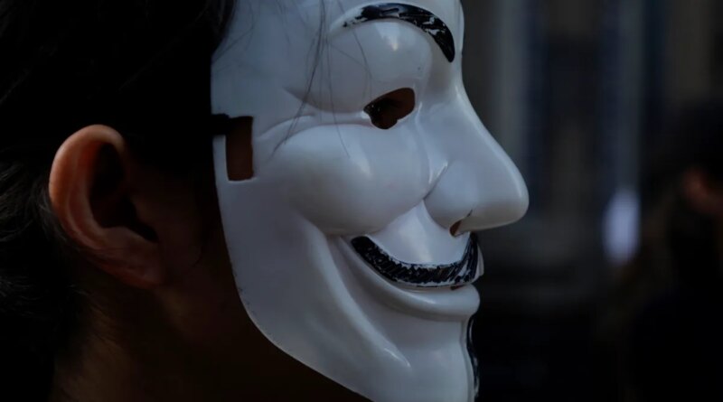 A member of the international organisation Anonymous for the Voiceless wears a Guy Fawkes mask while demonstrating in the streets of Mexico City's Historic Center.