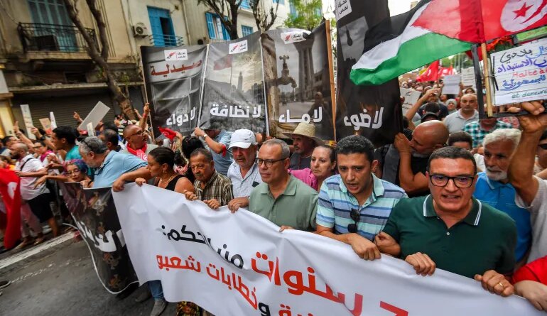People gather to protest Tunisia’s President Kais Saied during a demonstration marking five years since his suspension of parliament and assumption of emergency powers, in Tunis on July 25, 2026 [AFP]