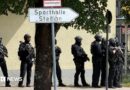Police officers stand with guns outside a school in Germany.