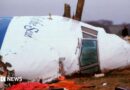 Officials inspect the wreckage of Pan Am flight 103 December 21, 1988 in Lockerbie, Scotland.