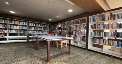 A man reads a book inside a library in Srinagar, February 17, 2025
