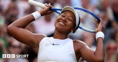 Naomi Osaka clenches her fist in celebration after beating Aryna Sabalenka
