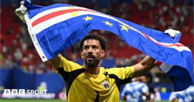 Vozinha holding Cape Verde flag