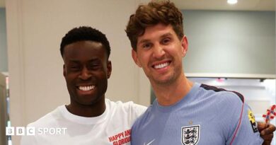 A picture of Guehi and Stones smiling at the camera at England's training camp in Kansas City
