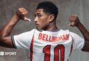 A picture of Jude Bellingham in a publicity shot wearing an England shirt, staring at the camera.