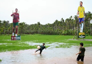 Children play football in front of cutouts of Portugal’s Cristiano Ronaldo and Brazil’s Neymar Jr put up by supporters ahead of the 2026 FIFA World Cup, in Kozhikode, India, on June 9, 2026