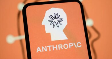 The Anthropic logo is displayed on the screen of a smartphone with the company's branding in the background.